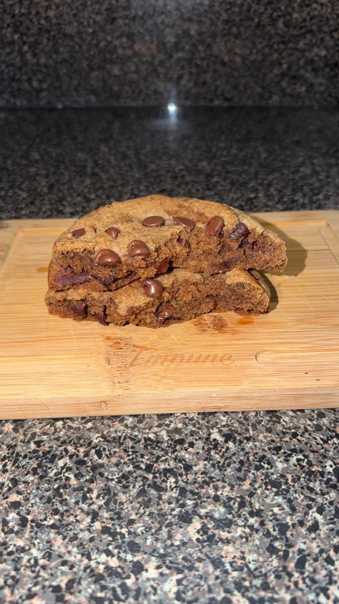 Double chocolate cookie sliced in half on a cutting board